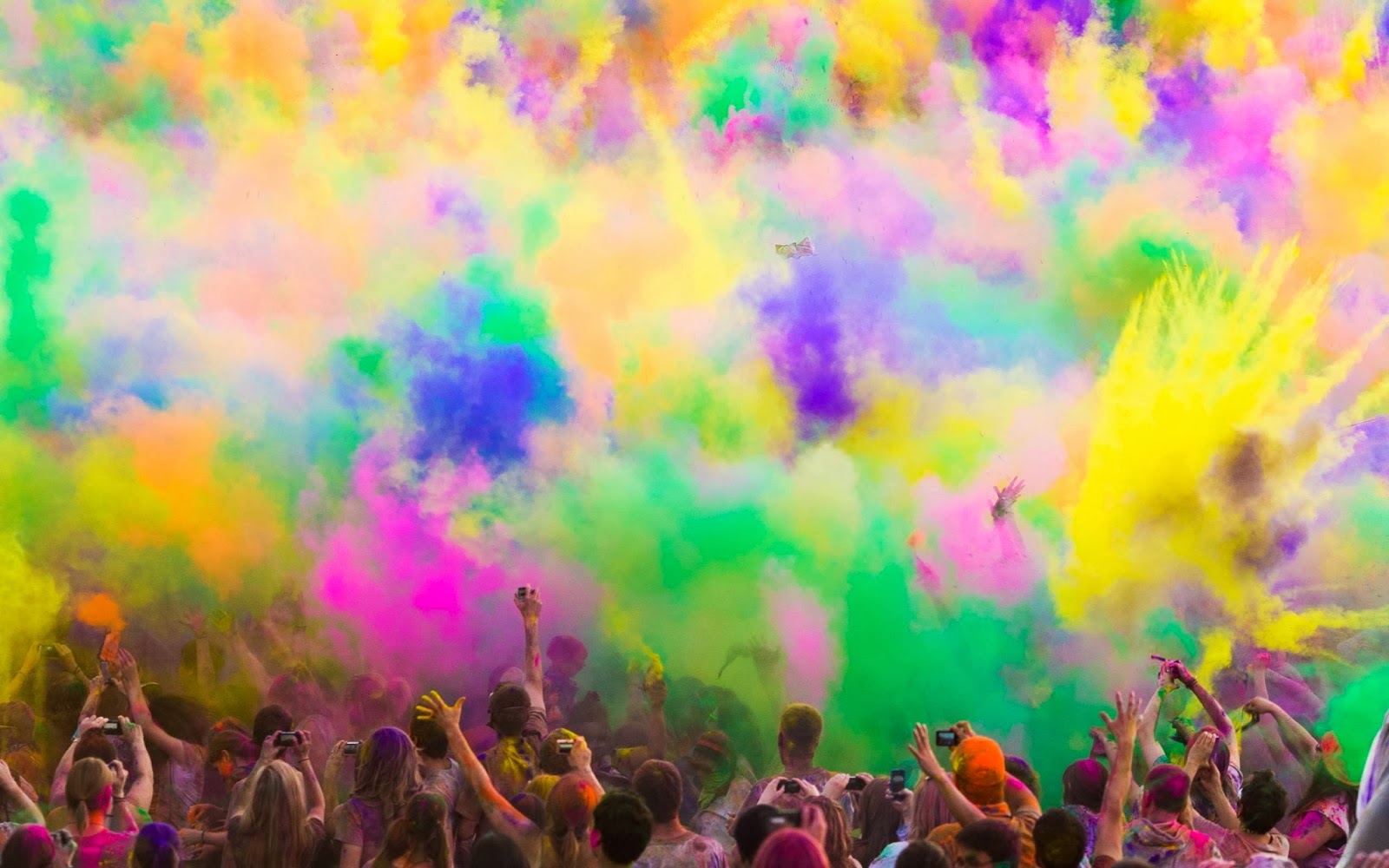 colourful cloud of powder paint above crowd