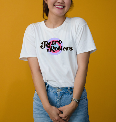 woman wearing a white t-shirt with the retro rollers logo on the front